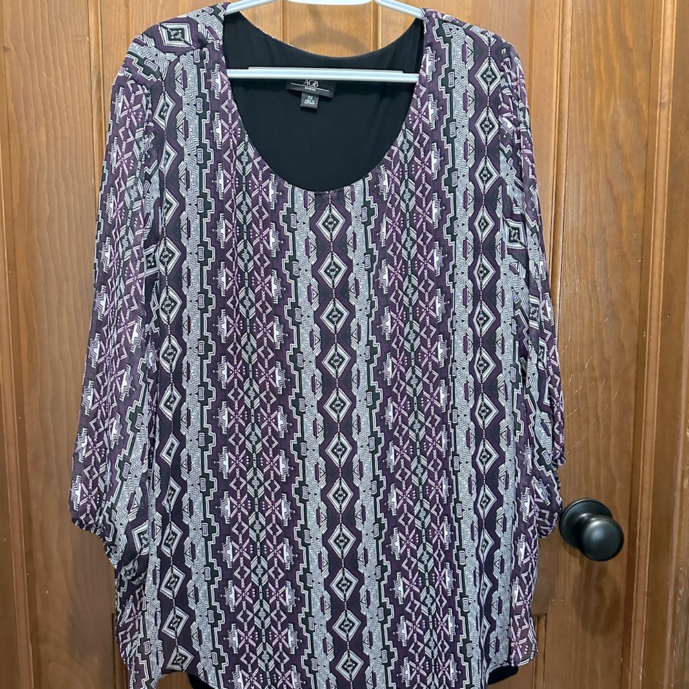 Plus size top in a print of lavender, black and white.